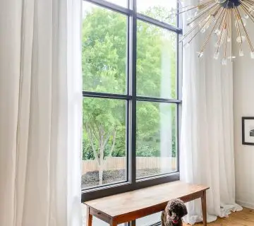 Custom tall sheer white linen curtains for double-story living room window on Thou Swell #curtains #drapery #linen #livingroom #livingroomdesign #livingroomdecor #homedecorideas
