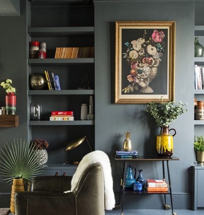 Dark green living room walls with pops of color, eclectic home decor, living room design on Thou Swell #livingroom #livingroomdesign #livingroomdecor #greenlivingroom #darkgreen #darkgreenwalls #greenwalls